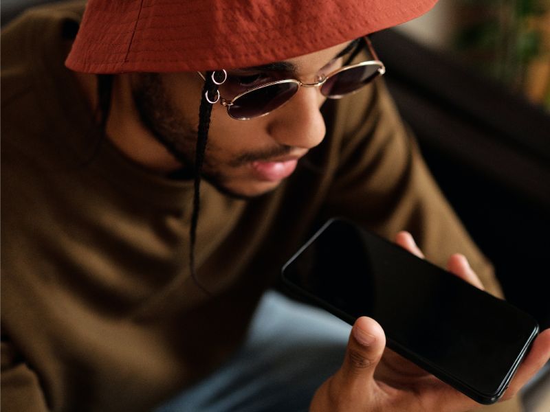 photo of a man speaking into his smartphone